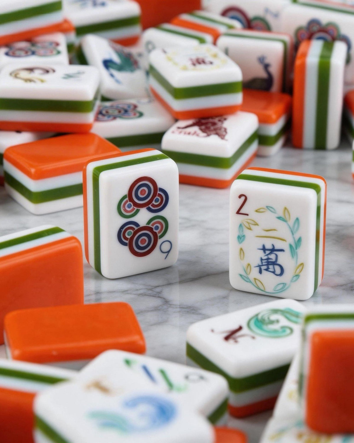 Scattered melamine mahjong tiles in orange and white with suit symbols and joker faces