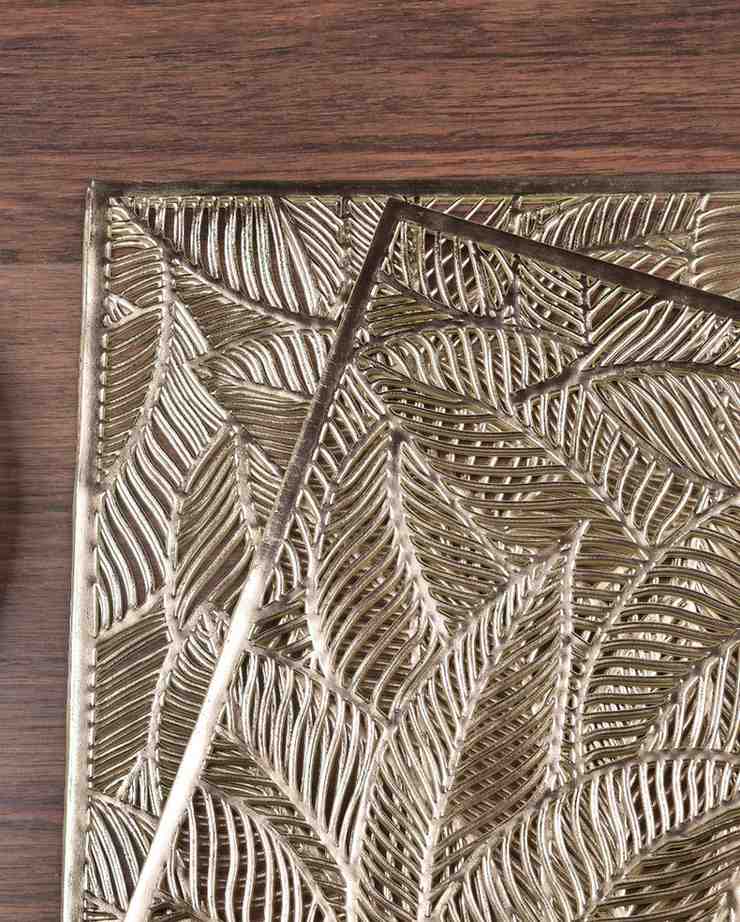 Rectangular placemat closeup with textured metallic gold leaf pattern