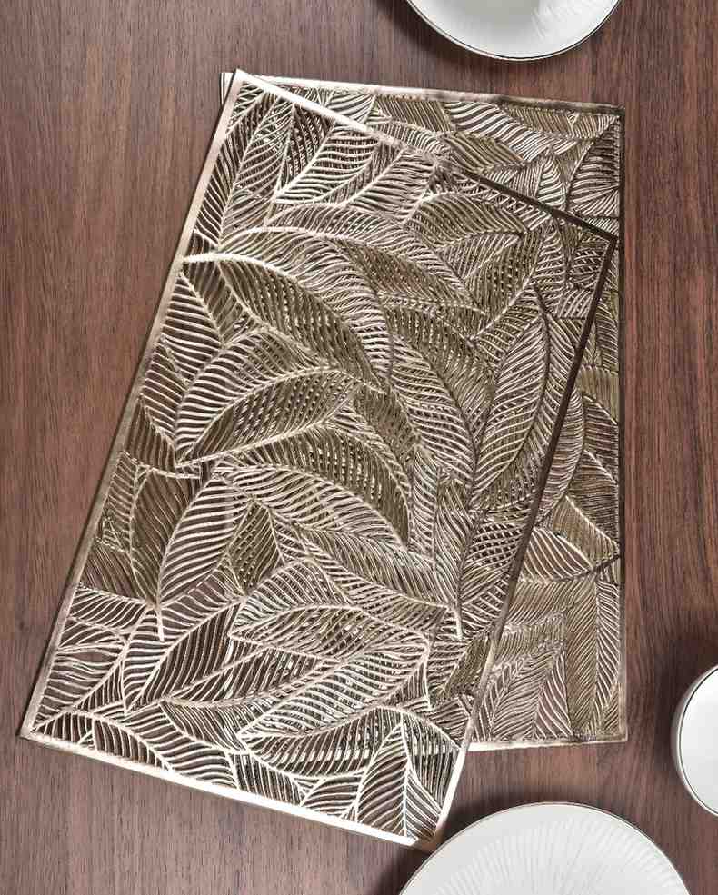 Rectangular metallic table mat with bold overlapping gold leaf design