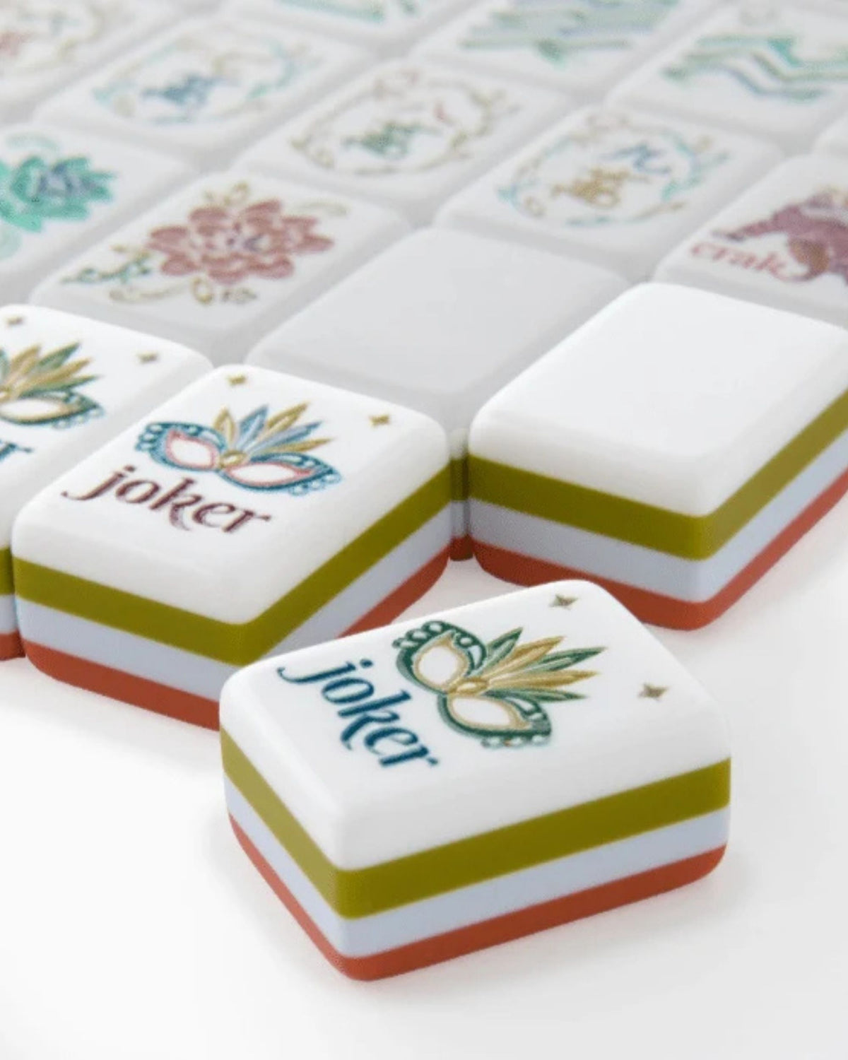 Close-up melamine joker mahjong tiles with colorful border stripes on white faces