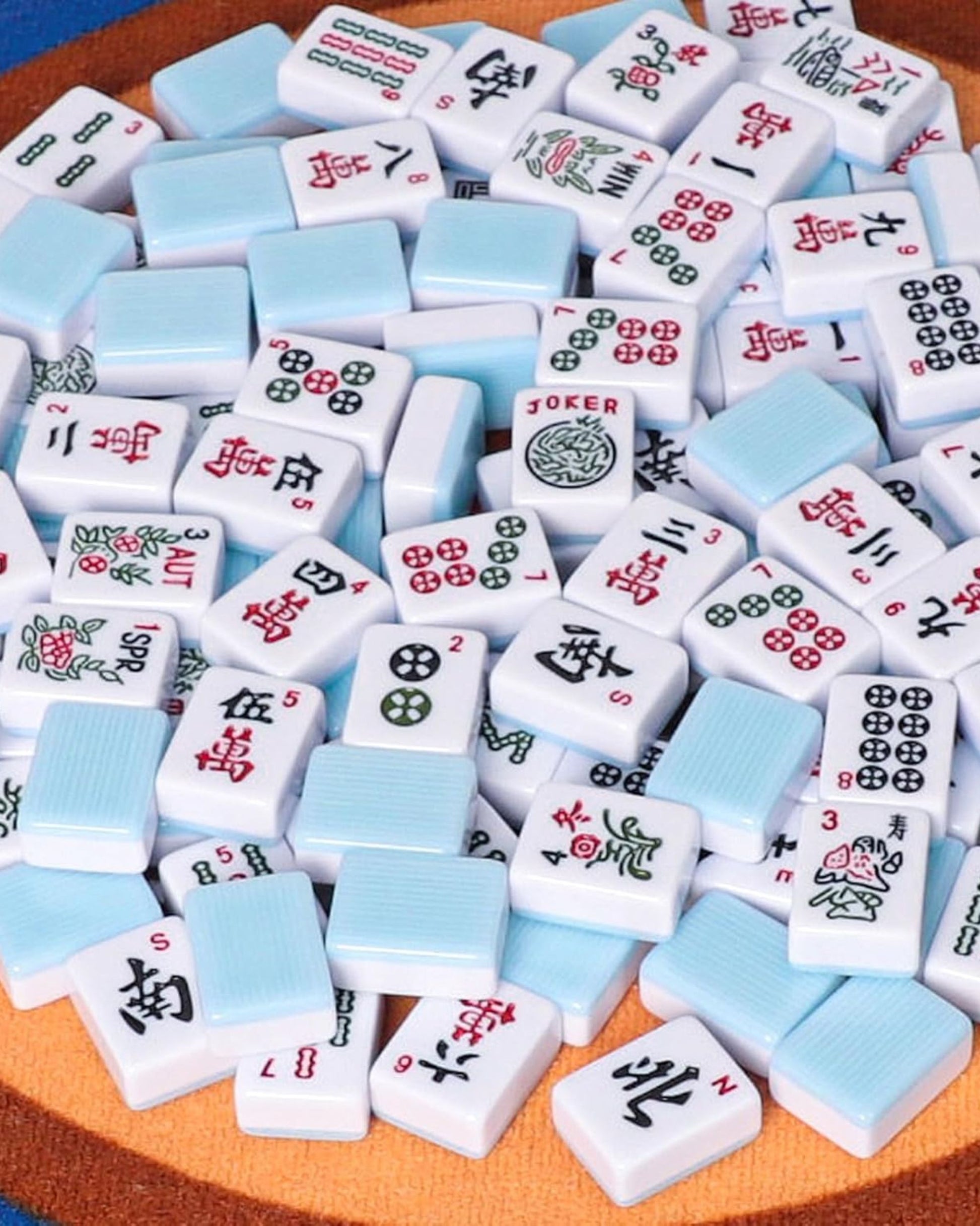 Assorted white and sky-blue mahjong tiles with 'JOKER' accents