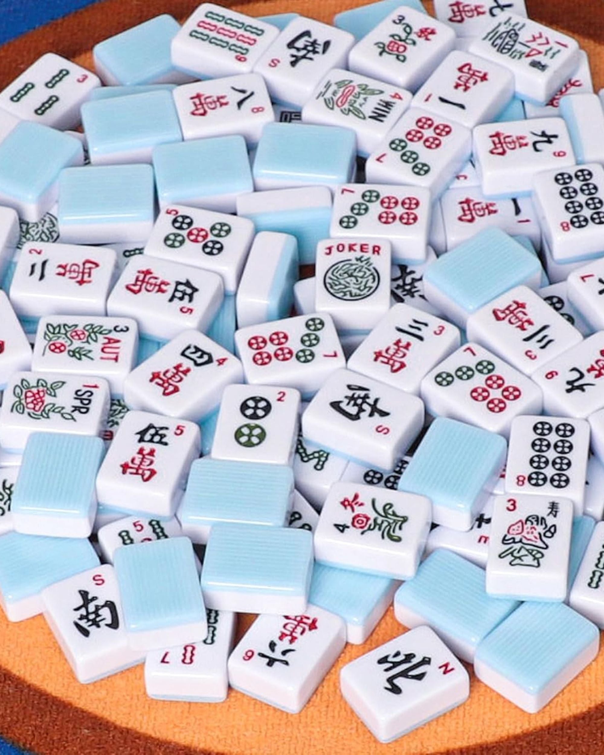 Assorted white and sky-blue mahjong tiles with 'JOKER' accents