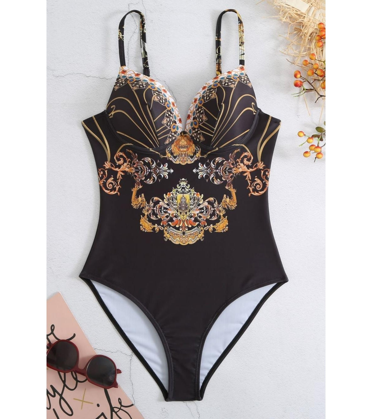 One-piece swimsuit with V-neck and deep backless cut, black with ornate gold print