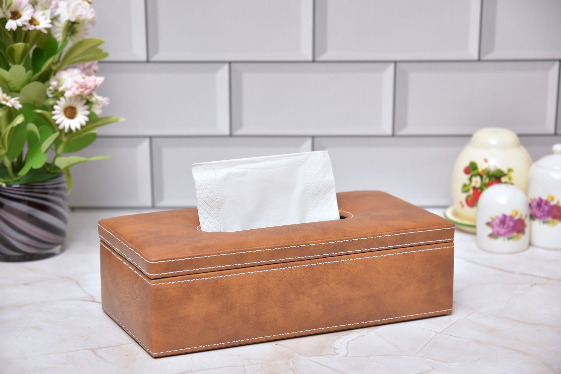 Rectangular tissue holder in tan leatherette with white tissues, open top