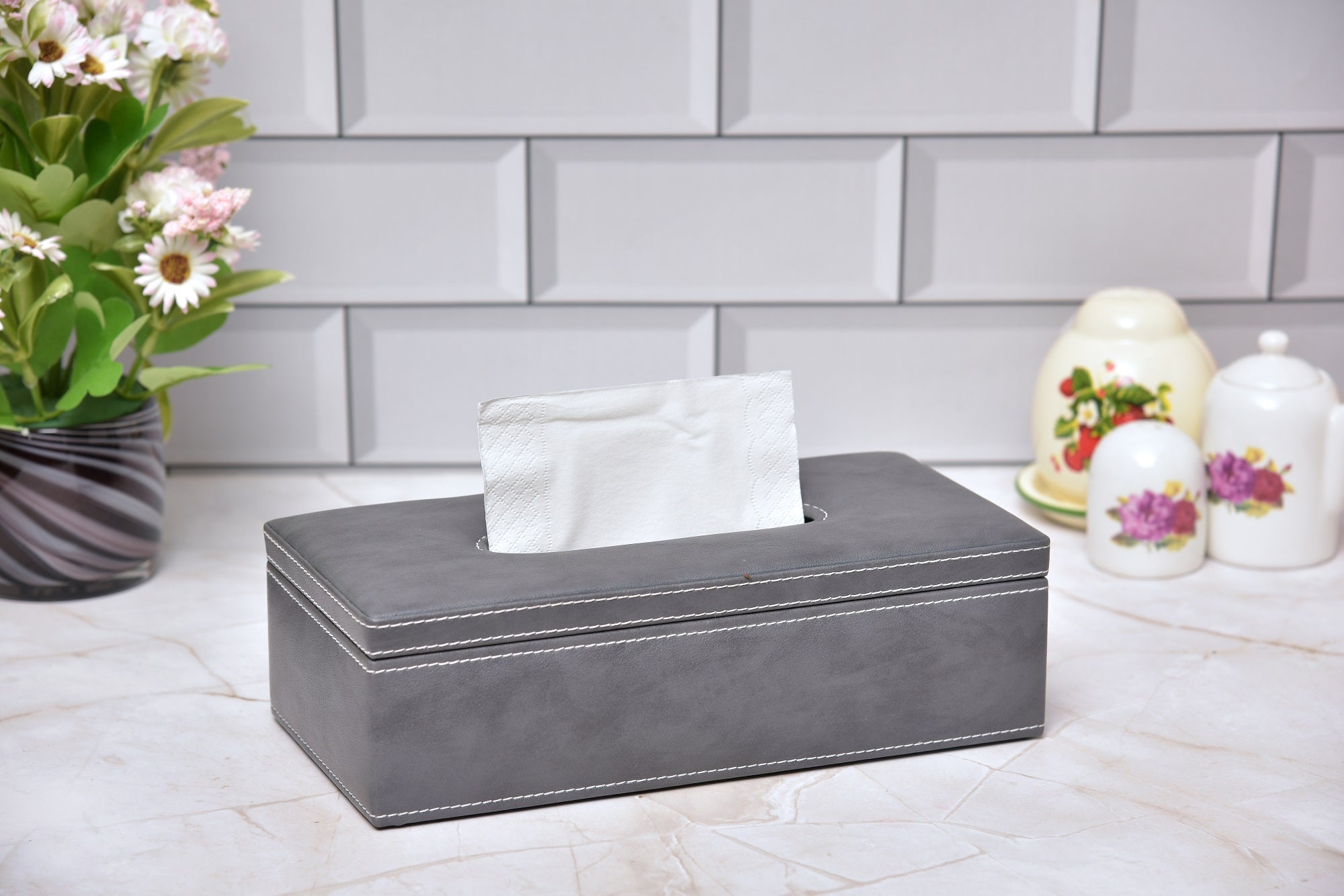 Rectangular tissue holder in dark gray leatherette with white tissues, open top