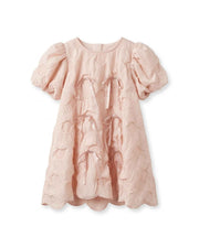 Blush pink textured girls dress with puff sleeves, round neckline, and drawstring bow