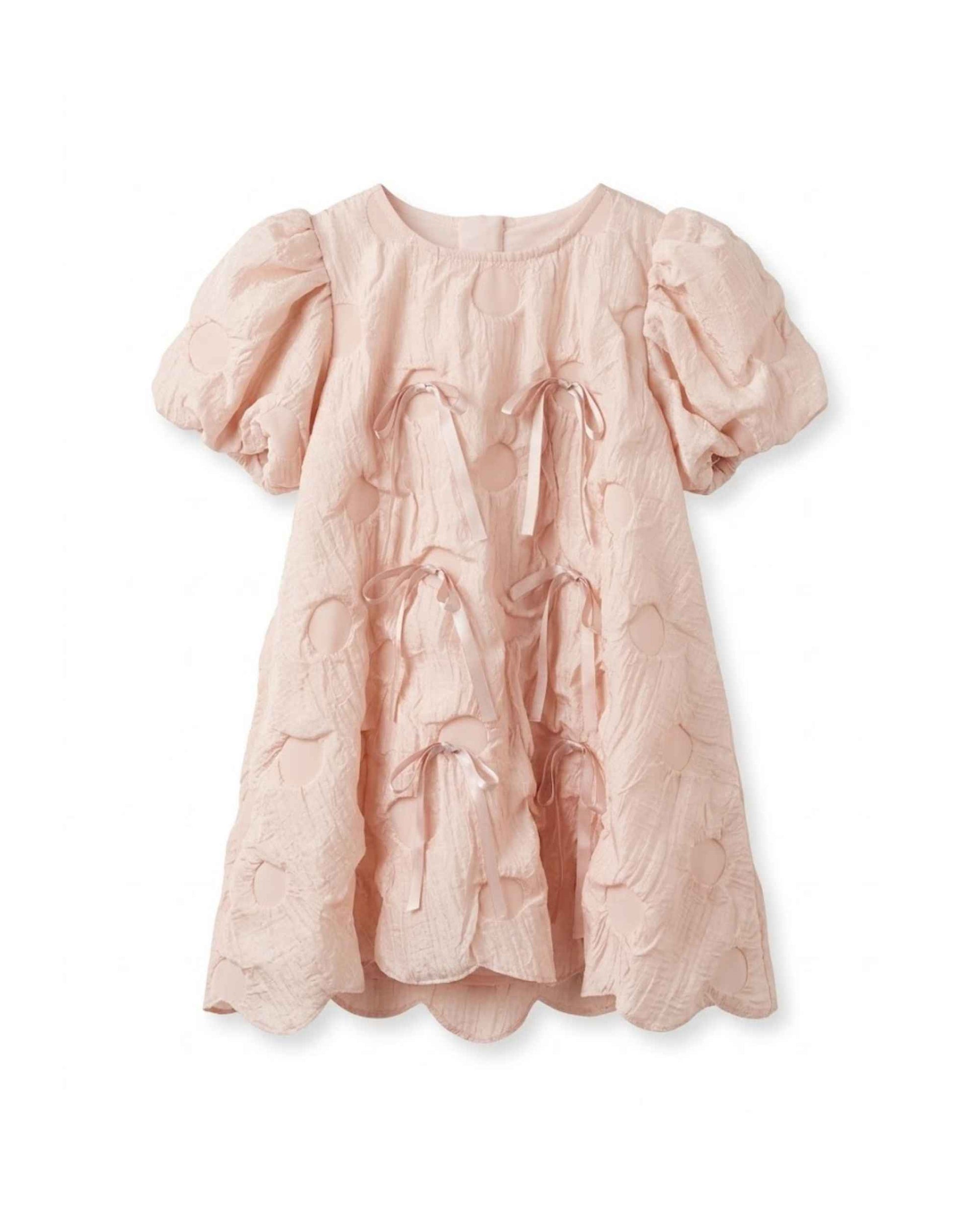 Blush pink textured girls dress with puff sleeves, round neckline, and drawstring bow