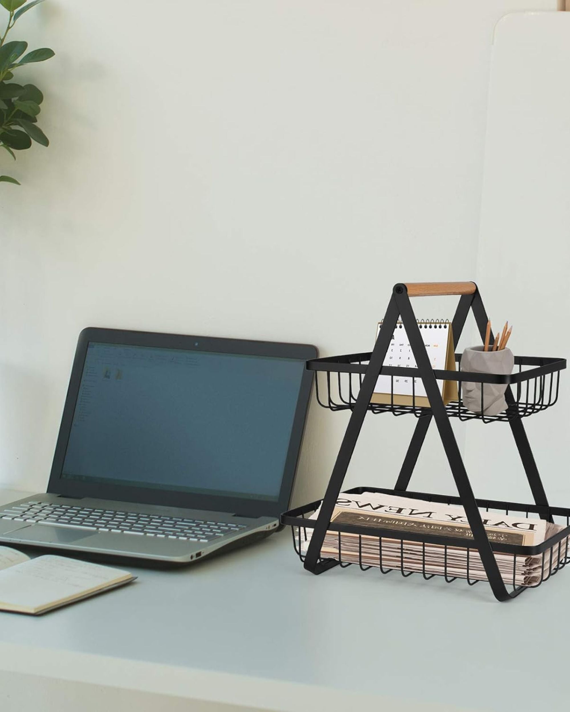 2-tier countertop storage stand with wire baskets and wooden handle, holding kitchen utensils