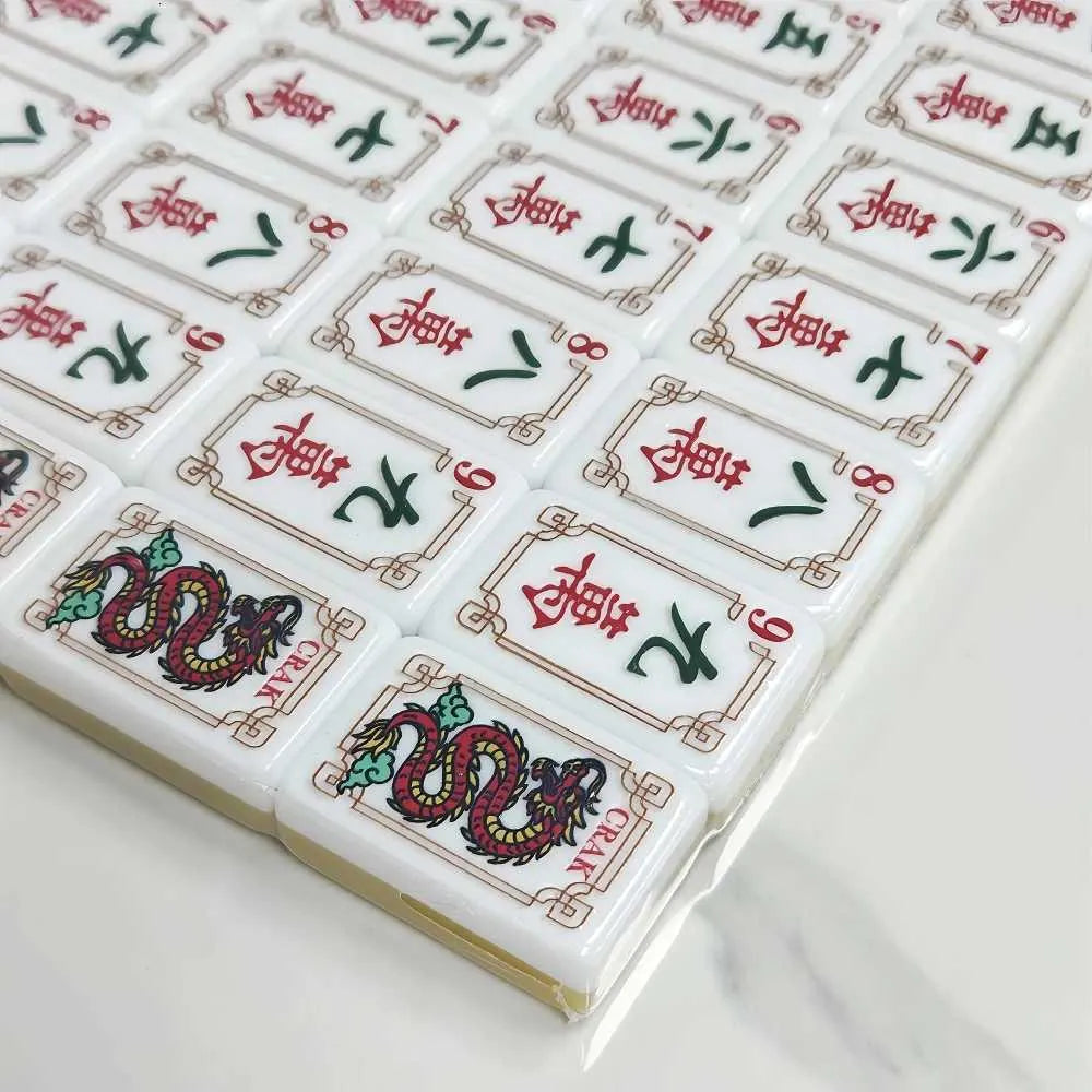 Mahjong tile set close-up with red and green dragon symbols on white faces