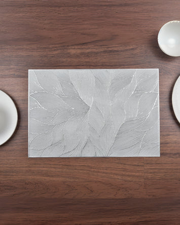 Rectangular metallic floral table mat, light silver with embossed leaf pattern, textured finish
