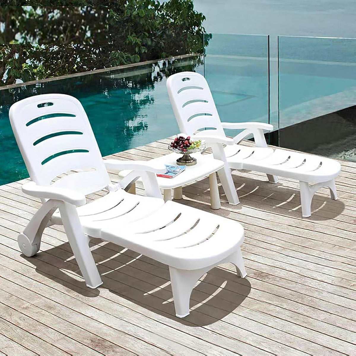 Set of two white plastic adjustable chaise loungers with curved slat seats and backs