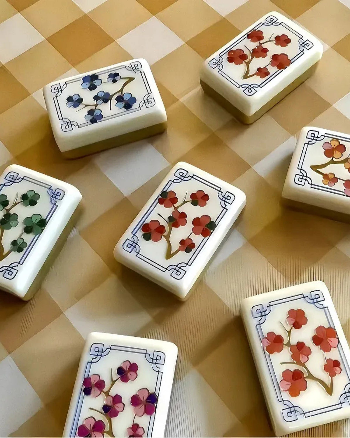 Mahjong tile set with white tiles featuring flower suit symbols in a layout