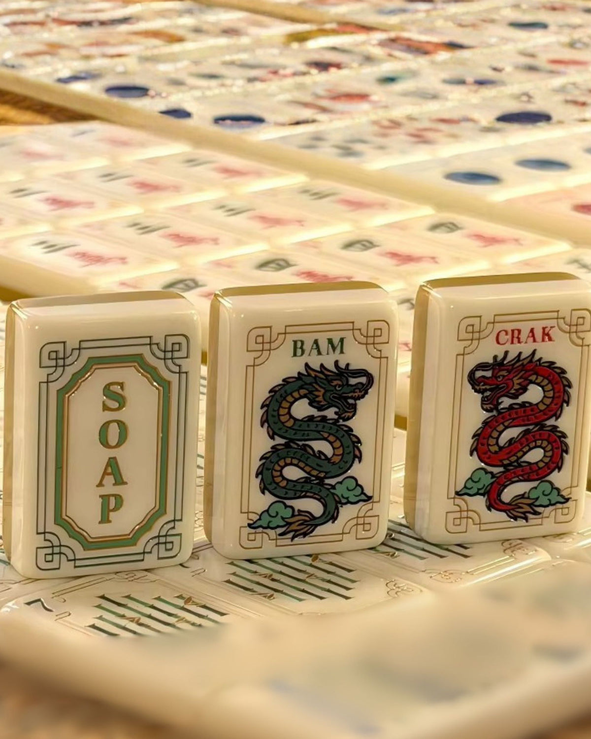 Mahjong tiles in a row featuring Dragon suit tiles with colorful illustrations