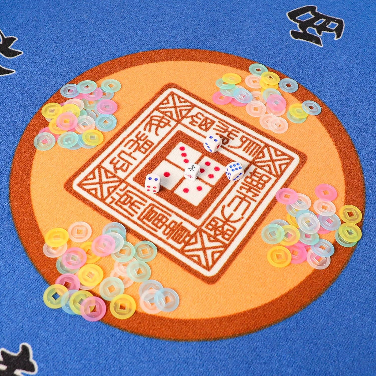Mahjong scoring chip tokens scattered around the center of a game mat