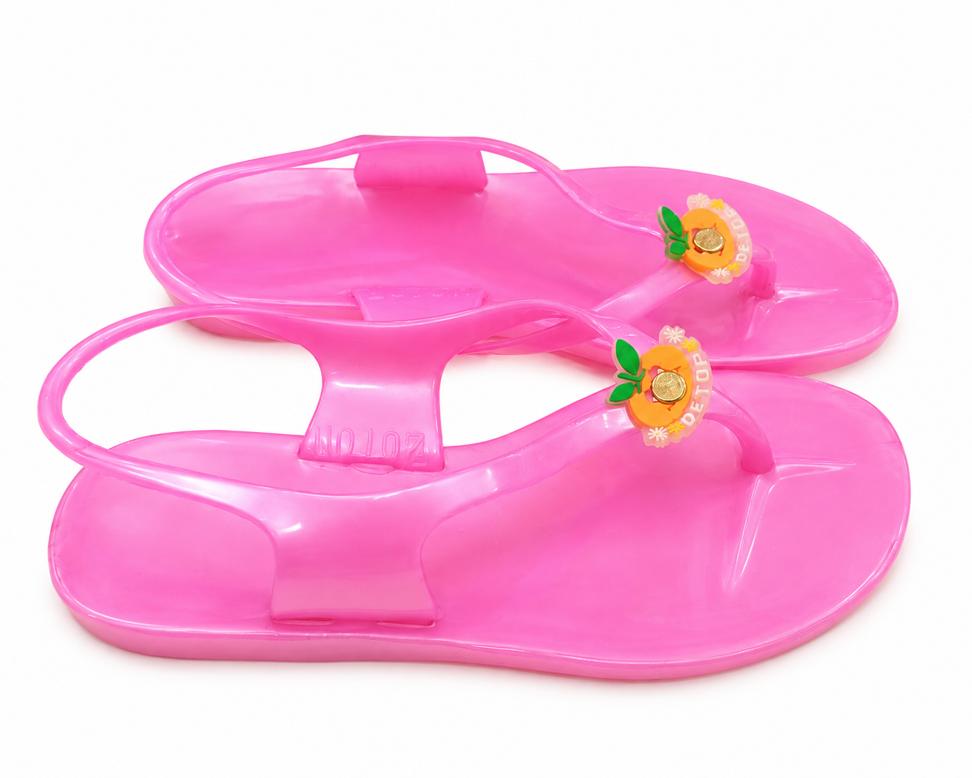 Bright pink jelly sandals with molded footbed and floral decoration