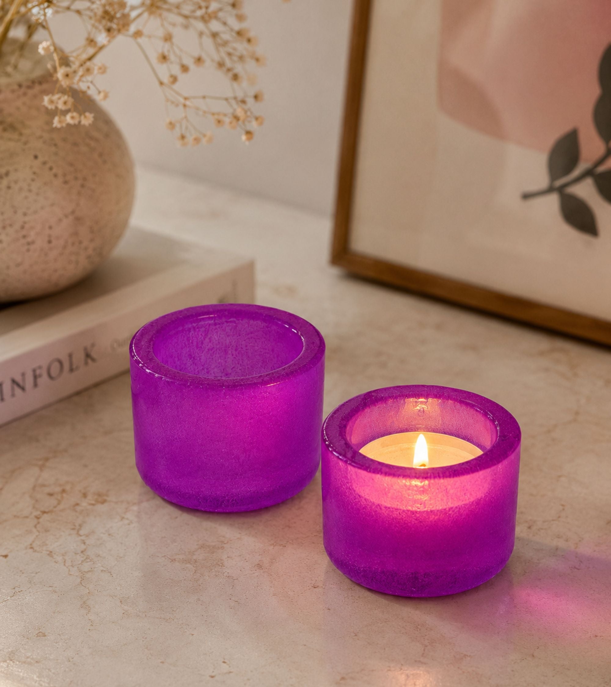 Purple glass votive candle holder with lit tealight, round cylinder