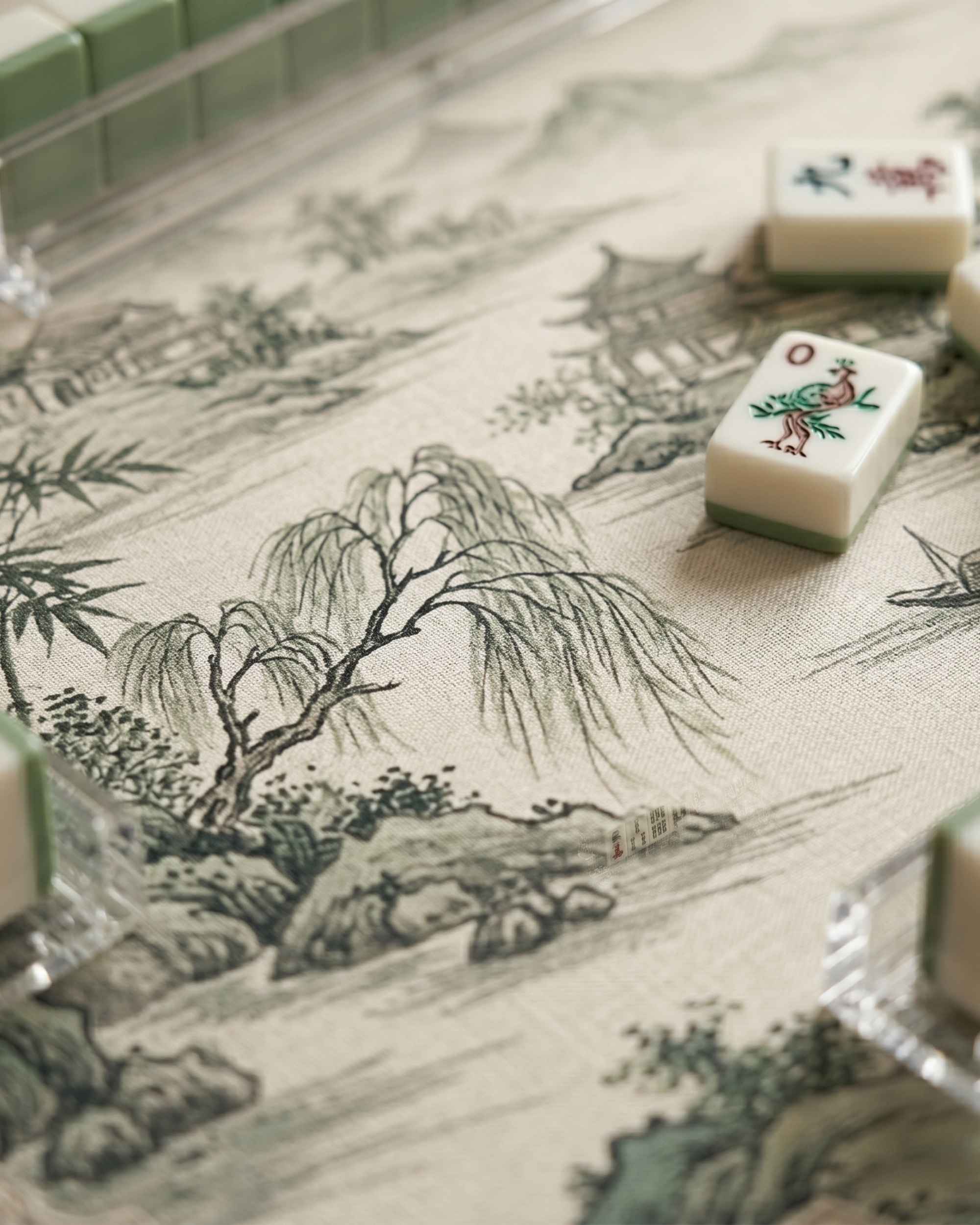 Square mahjong table mat with bamboo and mountains print and a few game tiles