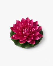 Artificial floating lotus flower with magenta pink petals and green base leaves