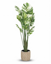Large artificial plant with green and cream variegated leaves in a ribbed pot
