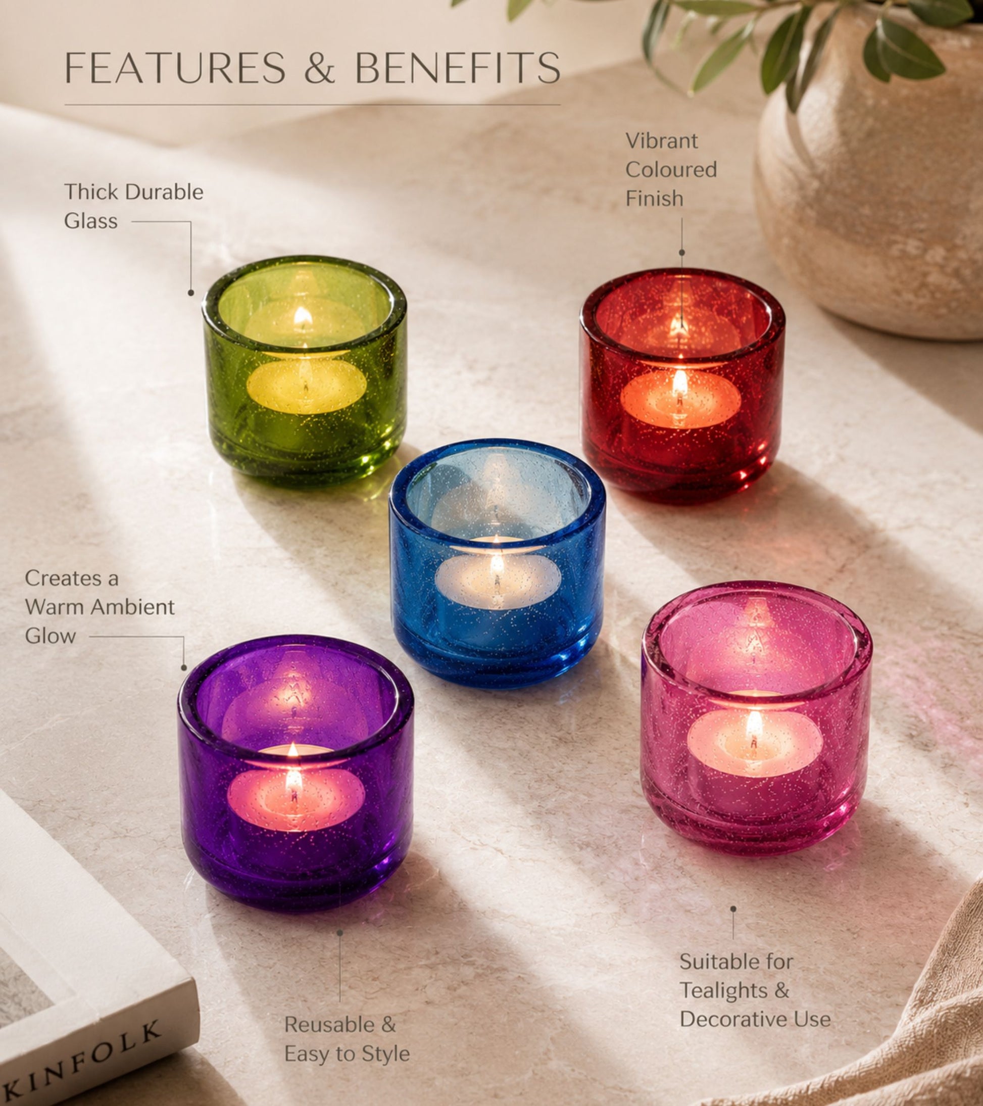 Glass votive candle holders in green, red, purple, and pink with lit tealights