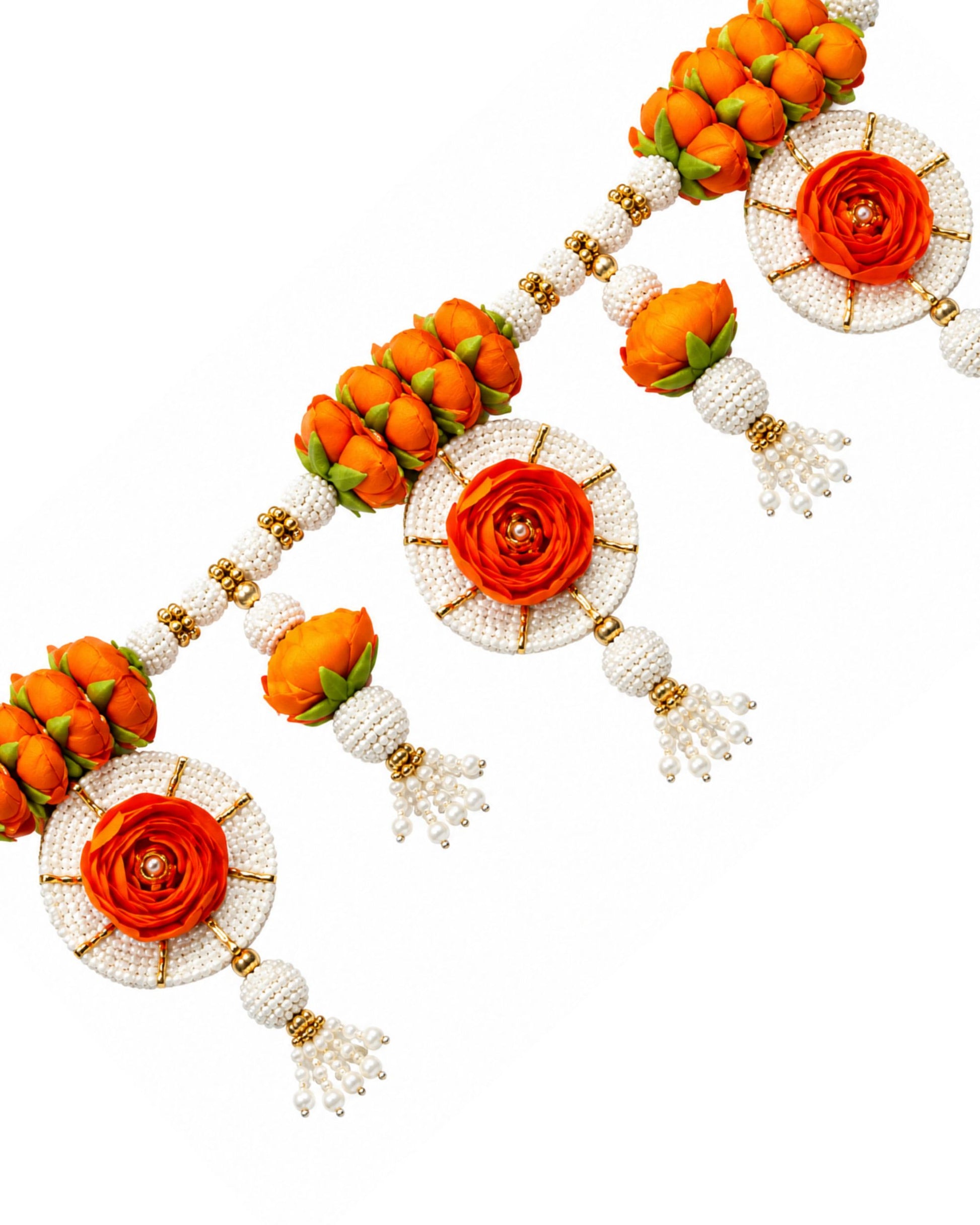Close-up of floral toran beads with orange rosette flowers, white pearls, and hanging tassels