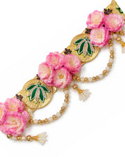 Close-up floral toran: pink flowers with gold leaf accents and pearl bead strands