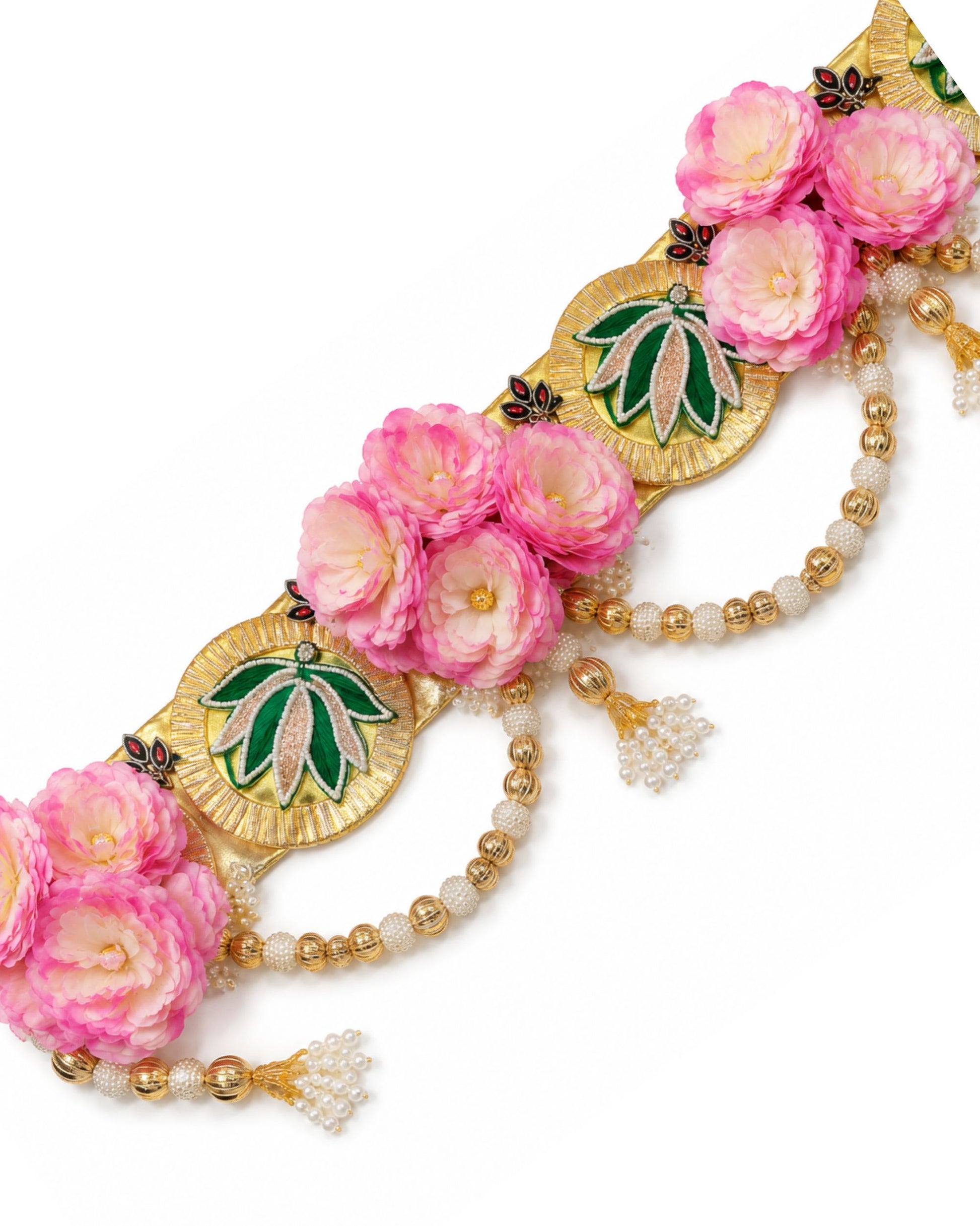 Close-up floral toran: pink flowers with gold leaf accents and pearl bead strands