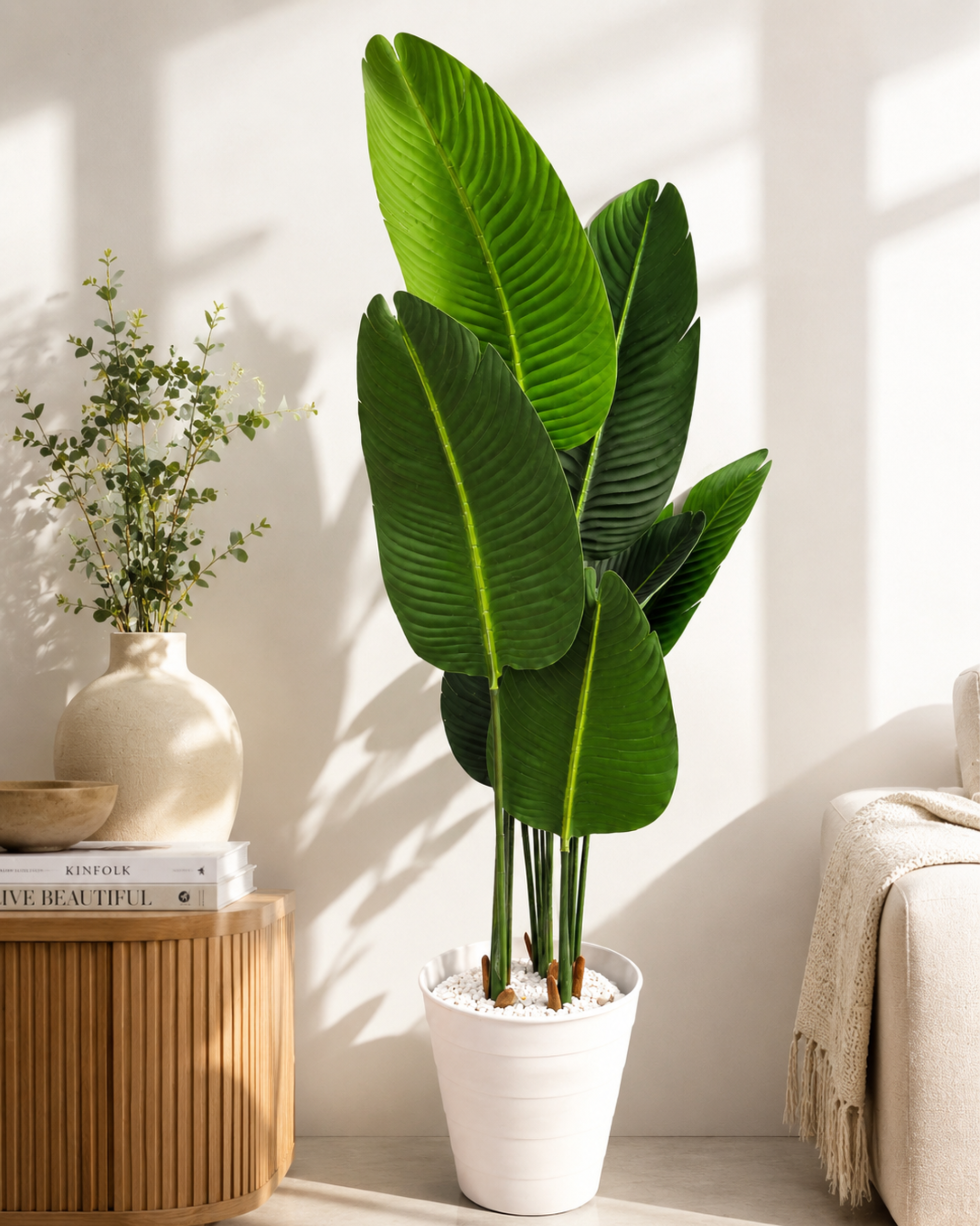 Artificial big-leaf plant with white pot, full green leaf cluster