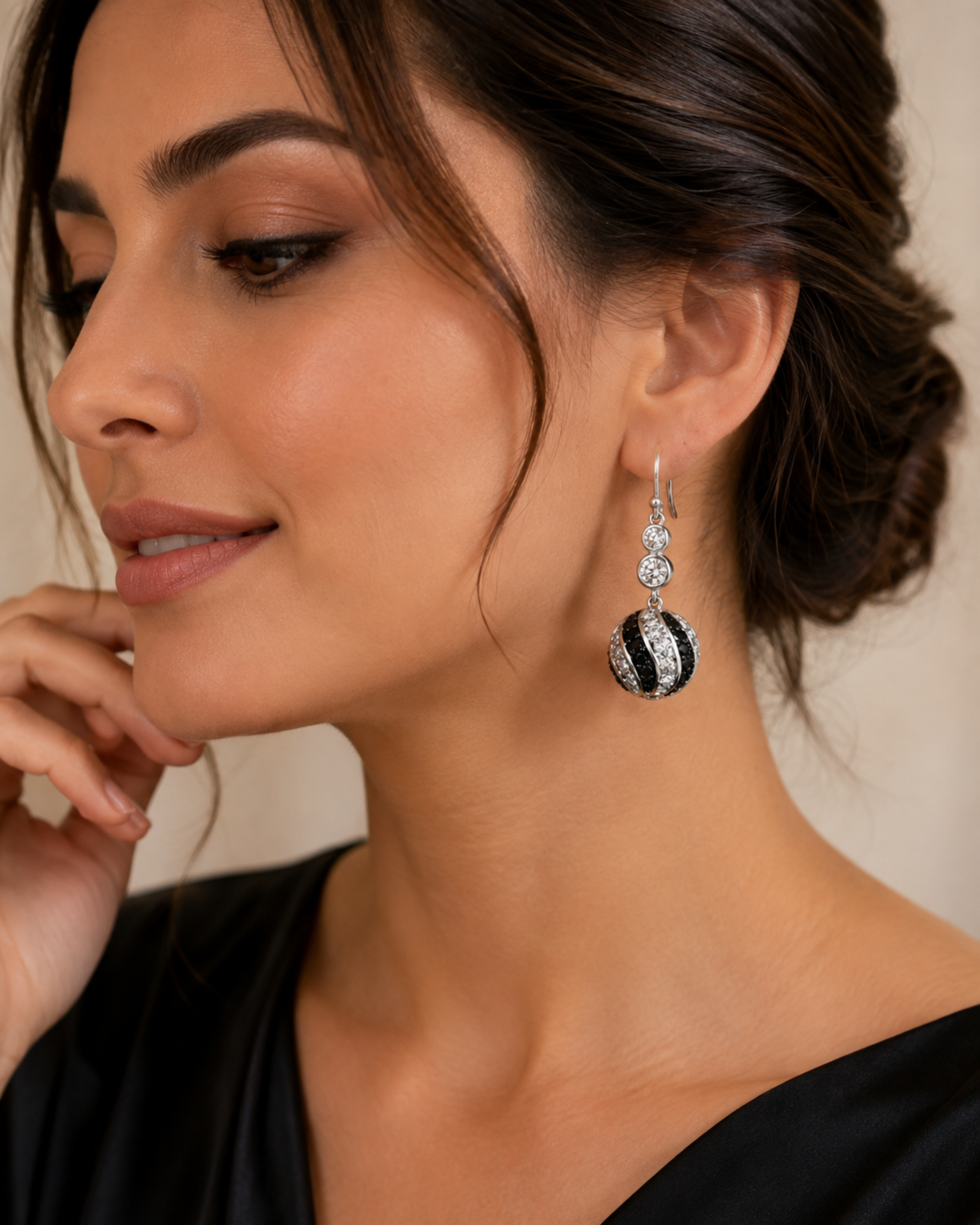Silver-tone crystal drop earrings with black center oval and dangling clear stones