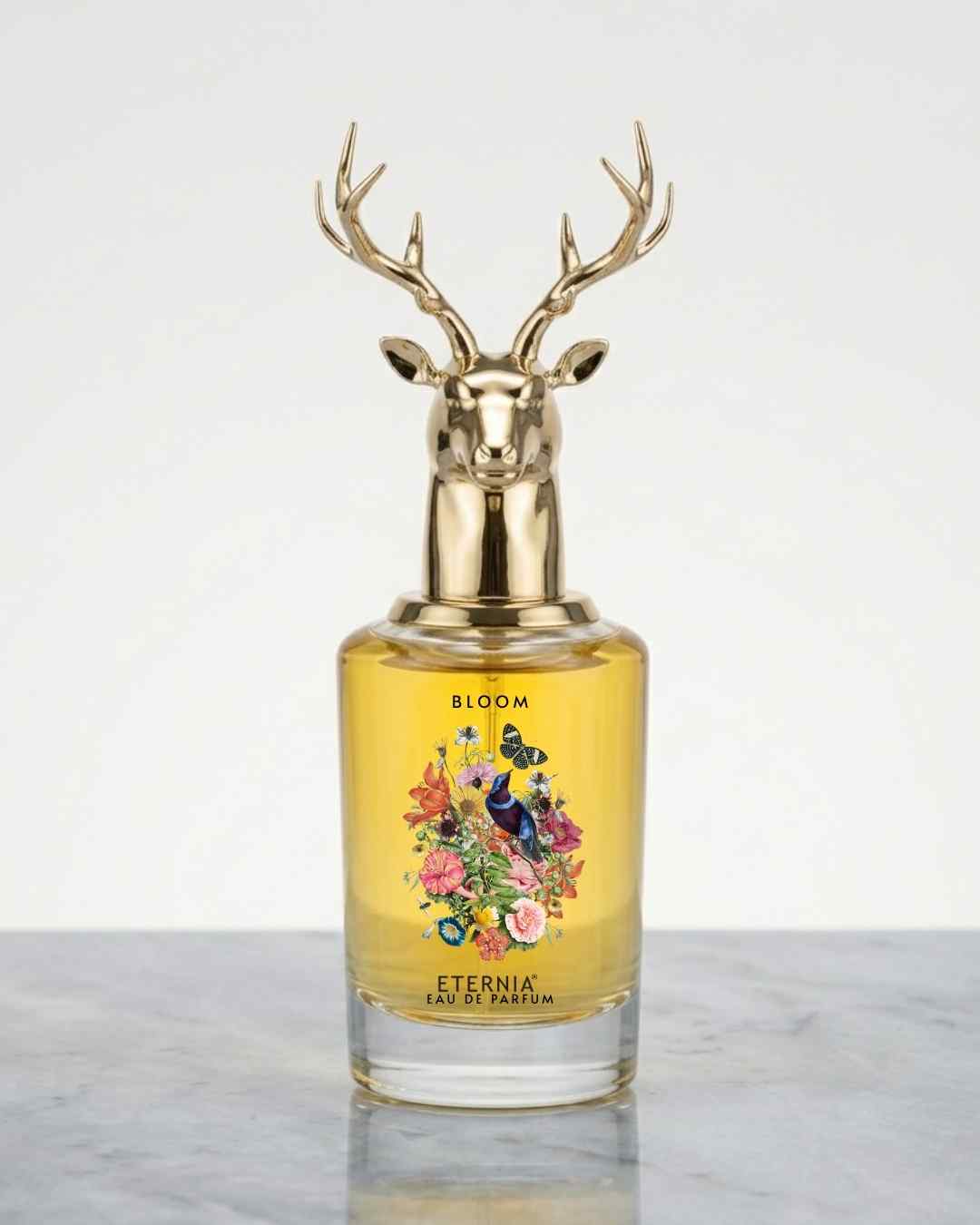 Eau de Parfum bottle with gold deer-antler cap and yellow floral label