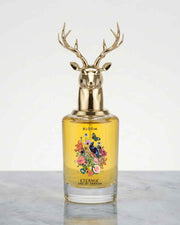 Eau de Parfum bottle with gold deer-antler cap and yellow floral label