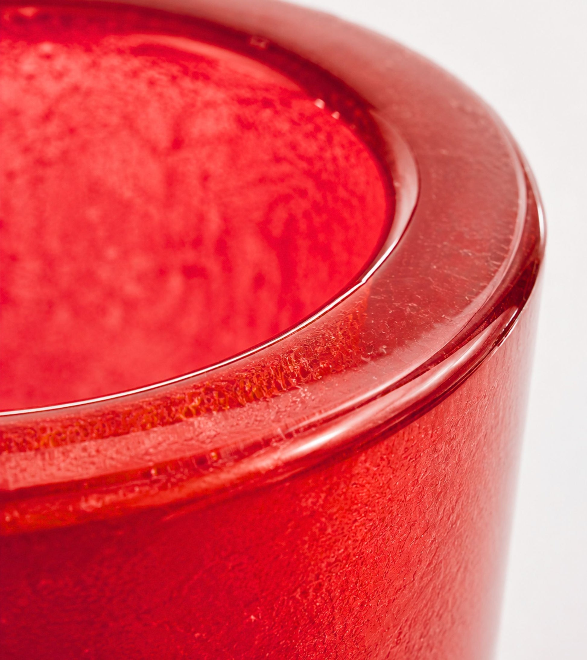 Red glass votive candle holder with curved rim
