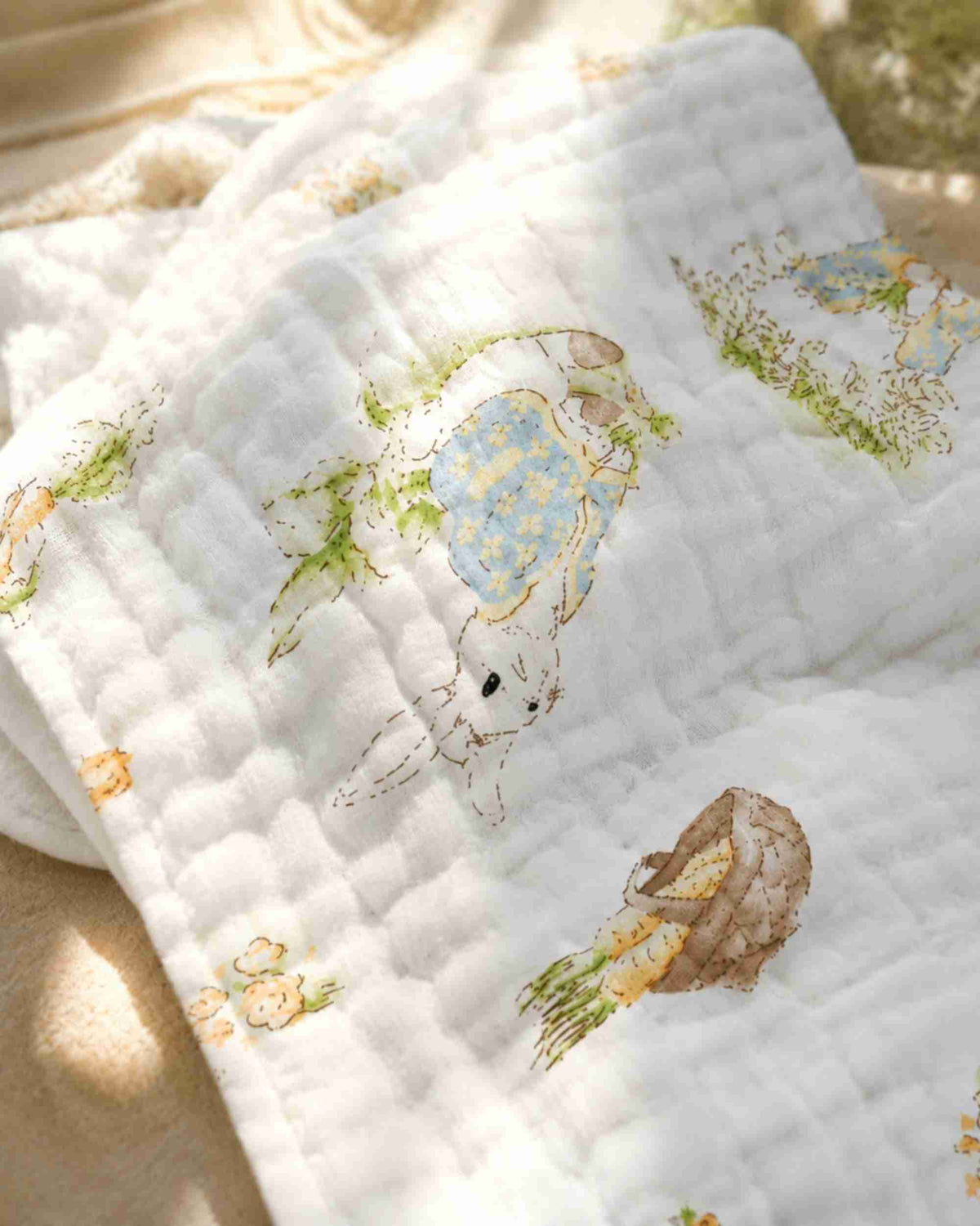 White baby burp cloth with stitched quilt pattern and bunny, carrot, garden print