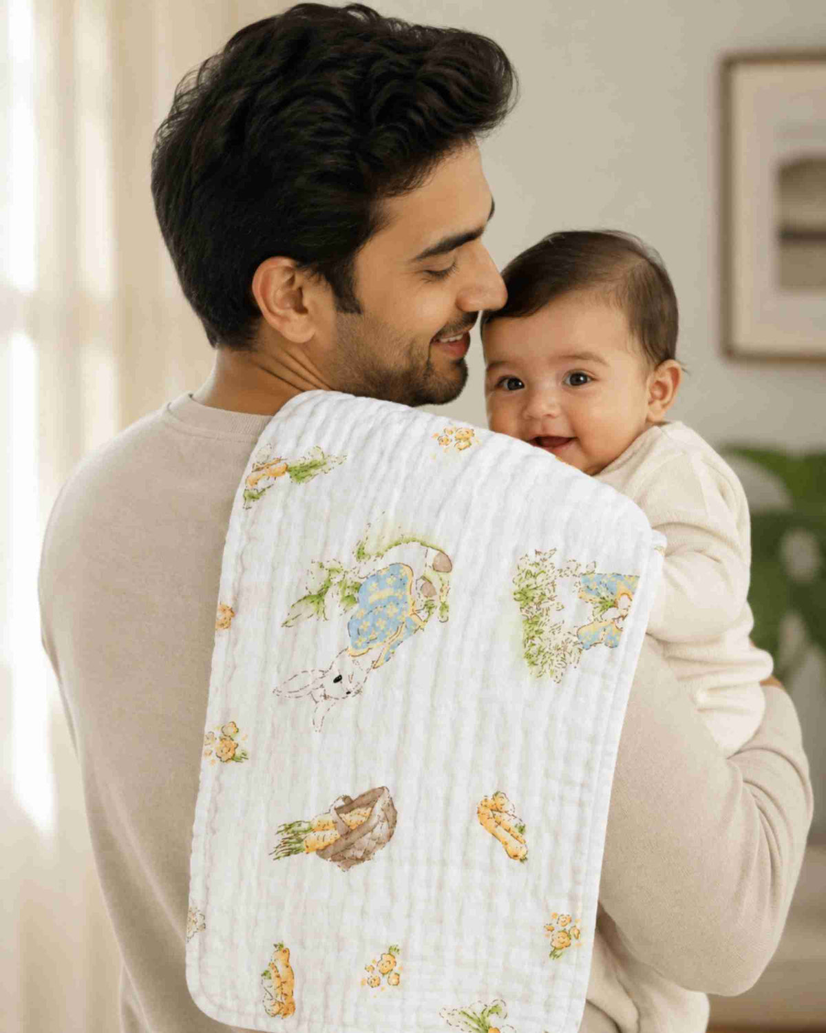 White burp cloth over shoulder, quilted fabric with bunny, carrot and garden illustration