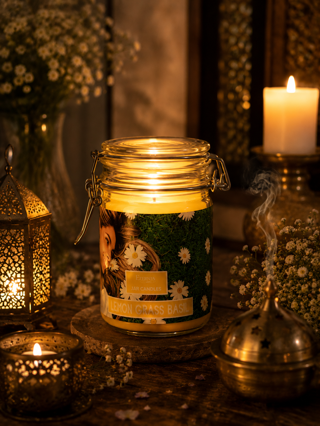 Jar candle in clear glass with metal lid, lit flame on stone base