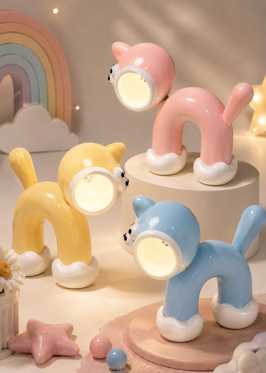 Cute cat LED night light in pink silicone with glowing round lamp head and curled tail shape.