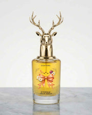 Eternia® Couture eau de parfum bottle with gold deer antler cap, yellow-gold liquid