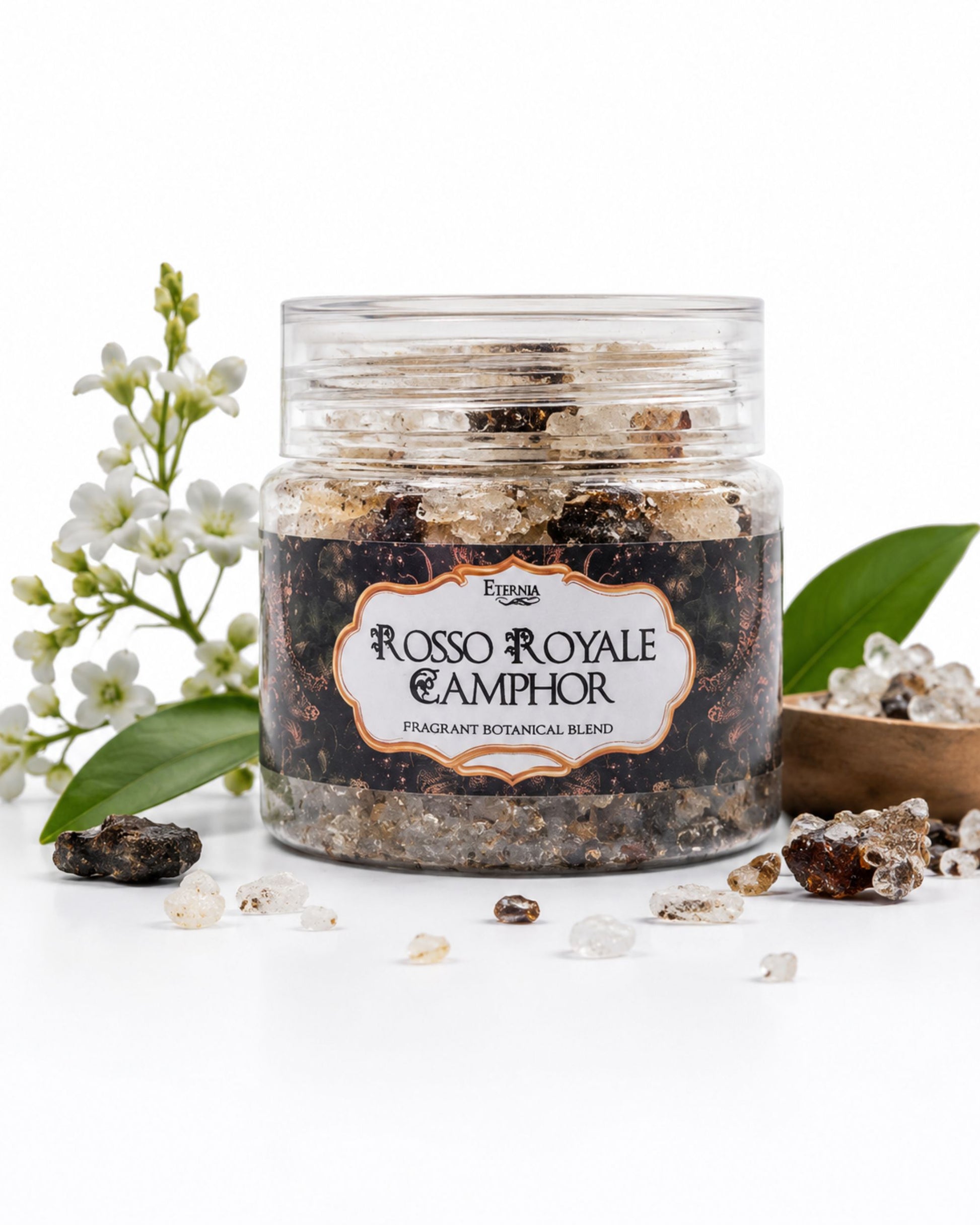 Clear jar of dark camphor blend aroma crystals with white crystals and green leaves