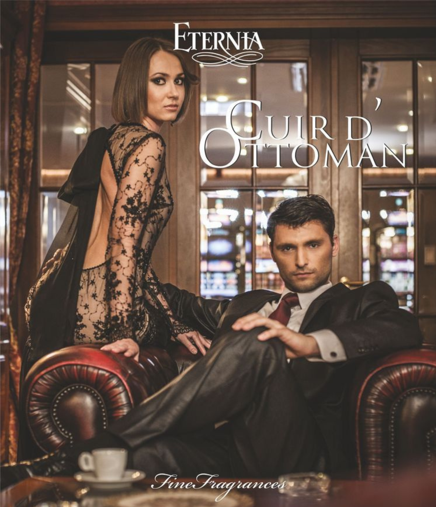 A woman in a black dress with lace details and a man in a black suit sitting in a luxurious interior, with a focus on the brand 'Eternia' and the product name 'Cuir d\u2019Ottoman'.
