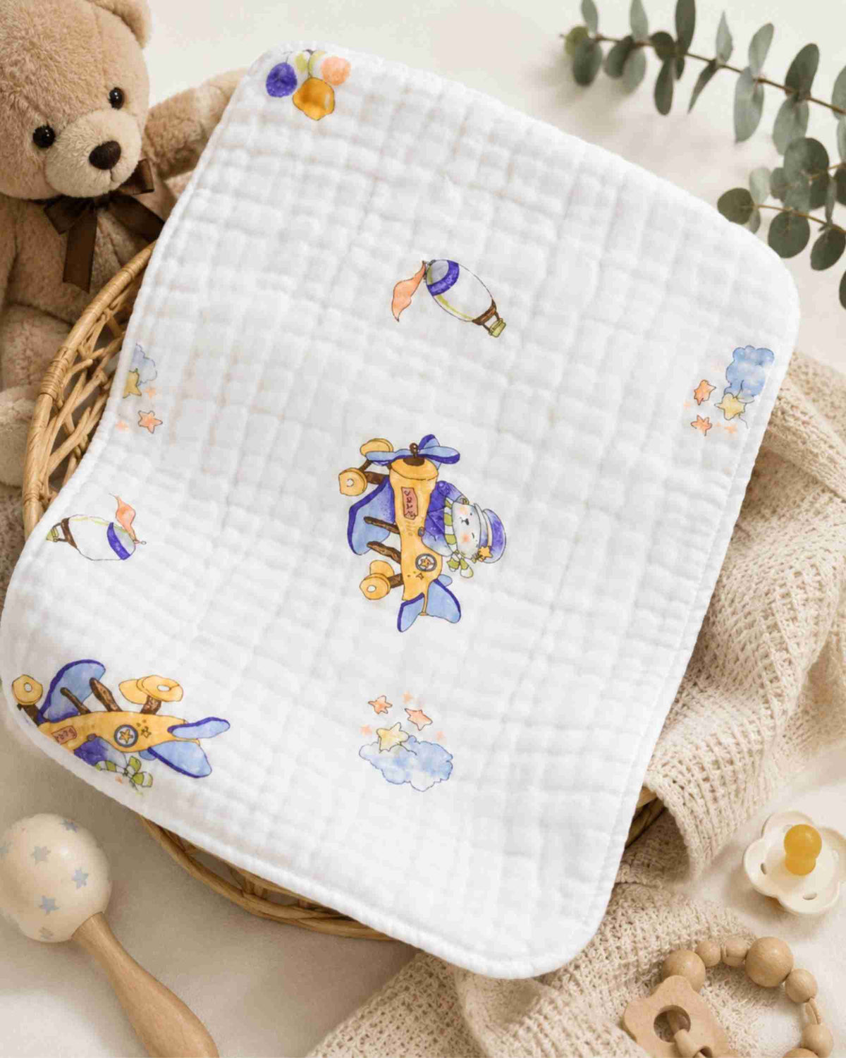 White quilted baby burp cloth with scattered airplane and star print