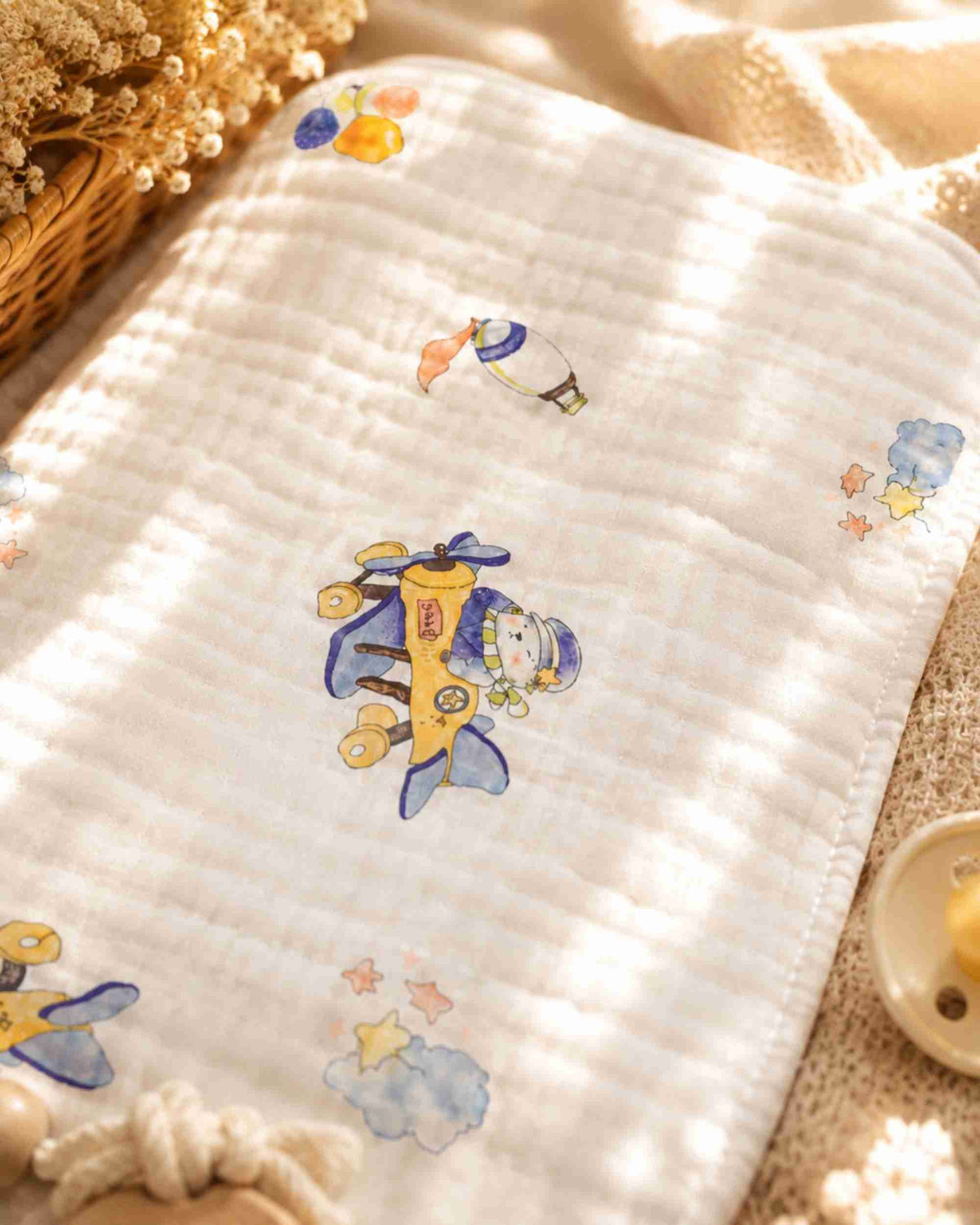 White quilted burp cloth with blue airplane and cloud print