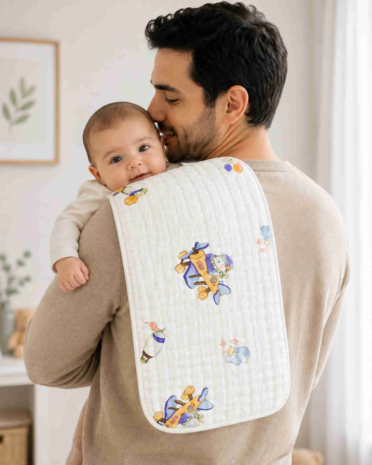 Baby burp cloth with white quilted fabric and blue airplane pattern