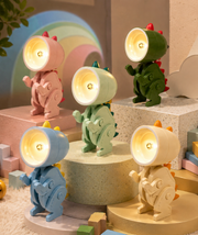 Mini dinosaur clip-on LED night lights in assorted colors arranged on display blocks