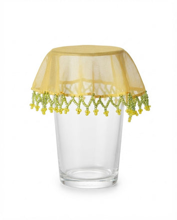 Yellow mesh drink glass cover with green beaded fringe and lace-style top