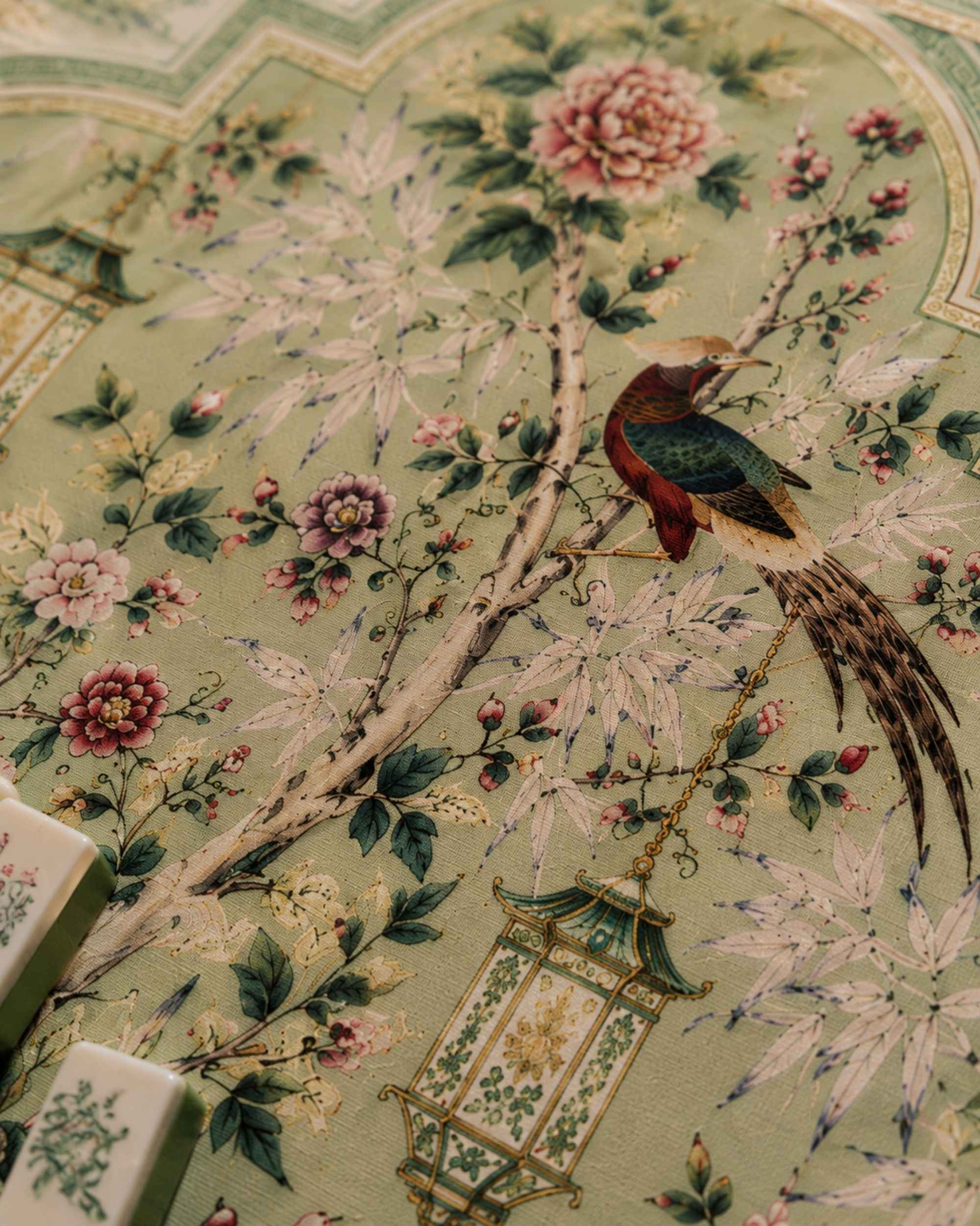 Floral mahjong table mat close-up with pink blossoms, leaves, and bird illustration