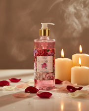 Pink liquid hand soap bottle with white pump and floral label