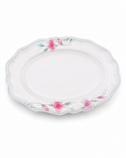 White oval melamine serving plate with pink and green lily blossom edge, scalloped rim.
