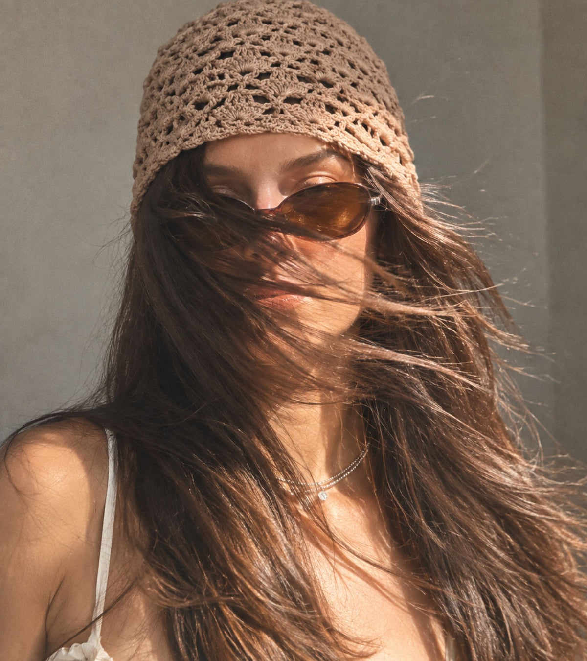 Eternia® crochet cap in beige, worn on model with side profile