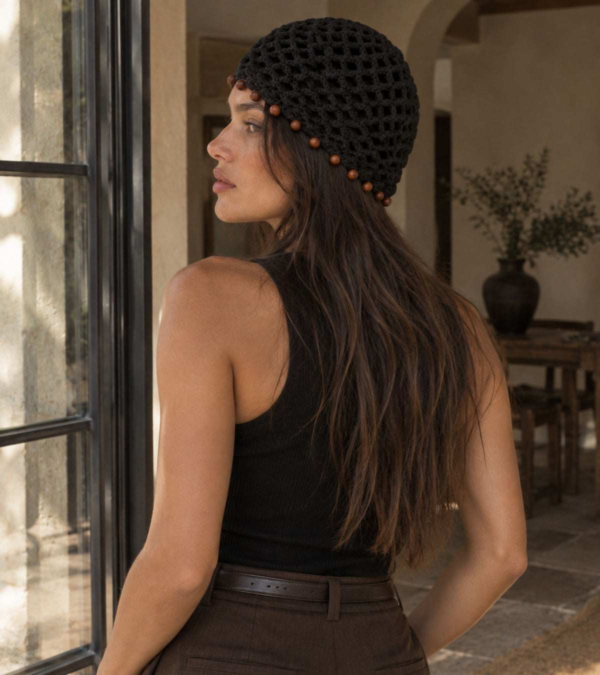 Black knit crochet beanie with brown beaded edge, back view