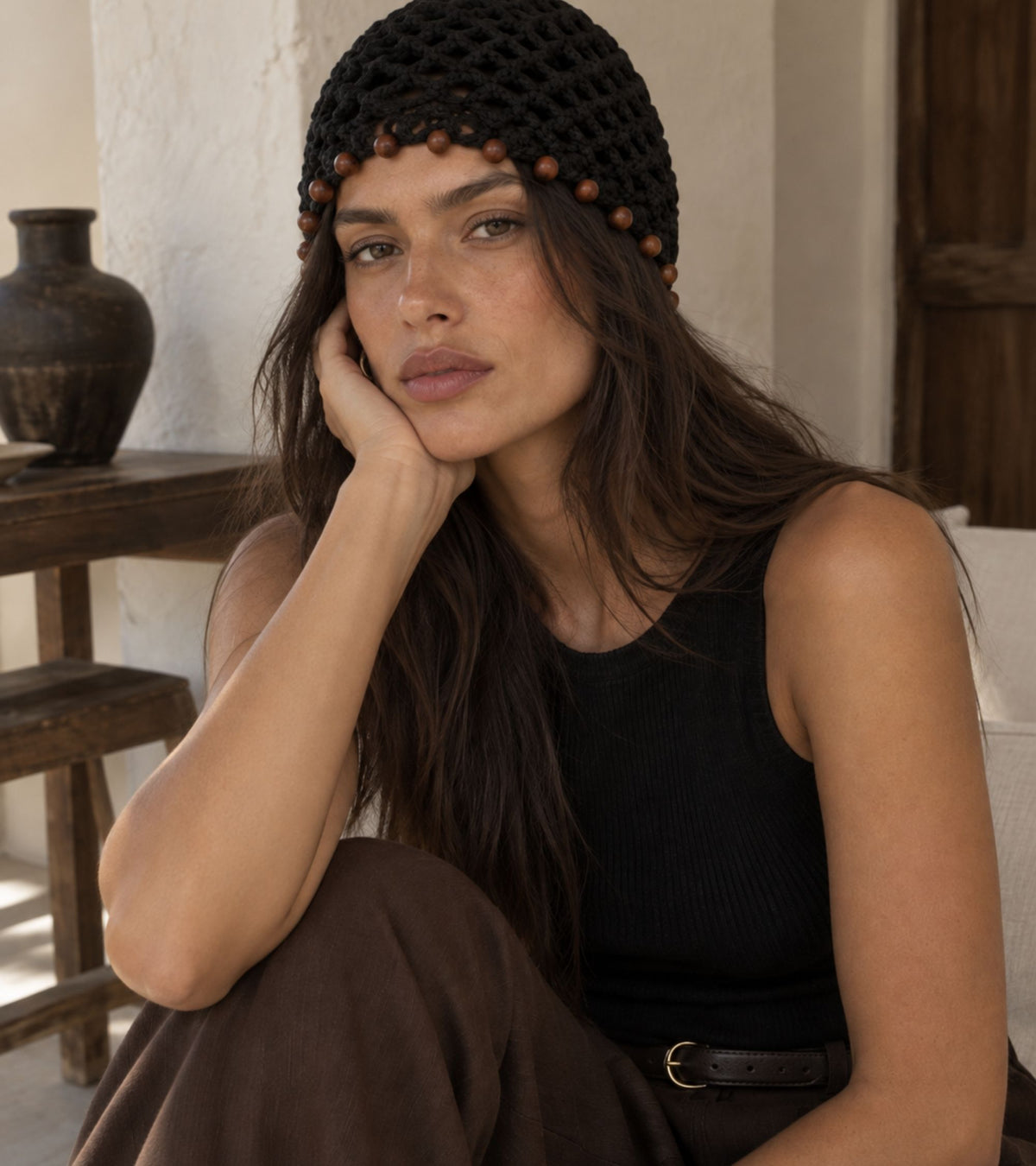 Black crochet beanie with brown beaded trim, front three-quarter view
